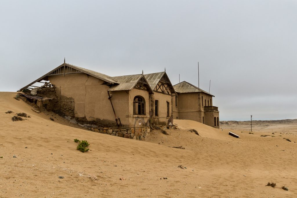 Häuser versinken im Sand